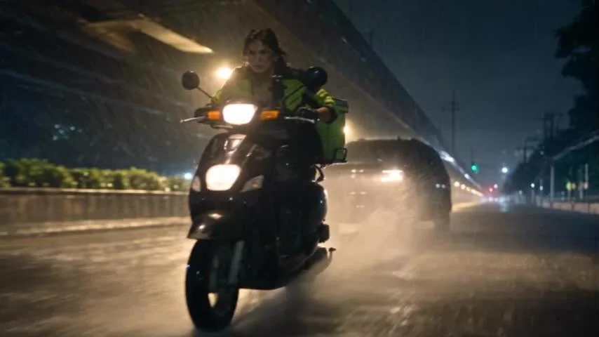 Raw Seedance output: Lia rides her scooter at night in the rain, headlight on
