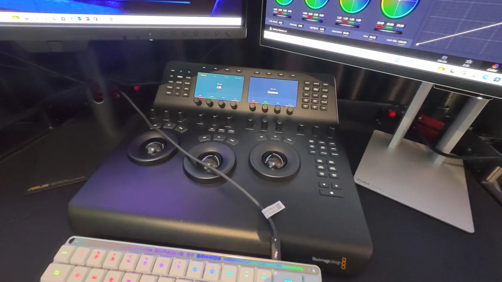 DaVinci Resolve grading panel beneath a ProArt monitor showing colour wheels